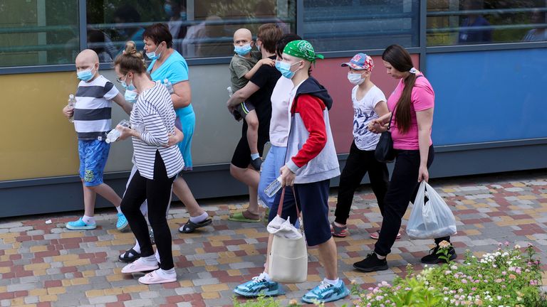 People walk near Ohmatdyt Children's Hospital that was damaged during Russian missile strikes, amid Russia's attack on Ukraine, in Kyiv, Ukraine July 8, 2024. REUTERS/Gleb Garanich