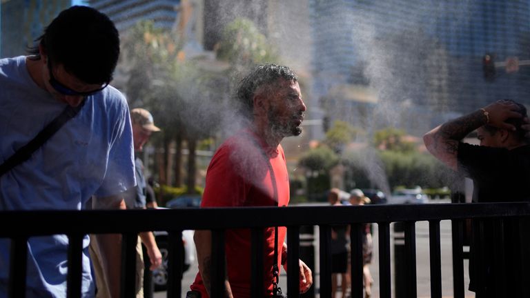 People cool off in misters along the Las Vegas Strip on Sunday amid record temperatures. Pic: AP