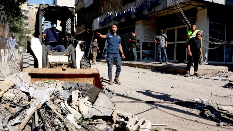 Police members remove the rubble at a damaged site the day after an Israeli strike, in Beirut.
Pic: Reuters