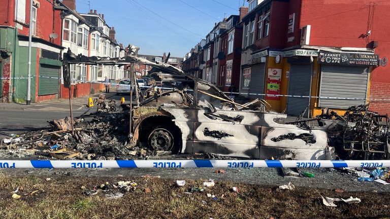 Vehicles were set on fire and a police car was overturned. Pic: PA