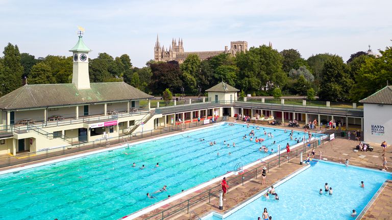 People cool off at Peterborough Lido.
Pic: PA