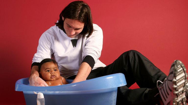 This photo taken in Sept. 2007 shows a 20-year-old Lionel Messi, who had embarked on his legendary Barcelona career just over four years prior, helping to bathe Lamine Yamal, who was merely six months old at the time during a photo session in the dressing room of the Camp Nou stadium in Barcelona, Spain. Lamine Yamal is now a soccer sensation for both Spain and Barcelona and he is still only 16-years-old. (AP Photo/Joan Monfort)