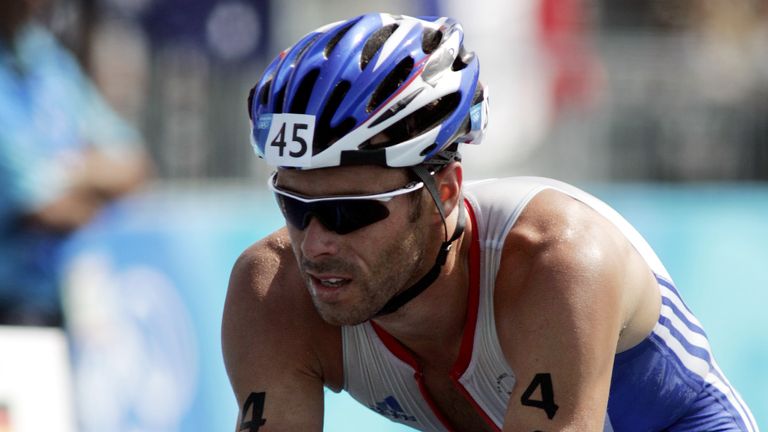 Britain's Marc Jenkins rides in the cycle section of the men's triathlon event at the Athens 2004 Olympic Games 25 August, 2004. Jenkins finished in 45th position after suffering mechanical failure during the cycle section. REUTERS/Mike Finn-Kelcey MFK