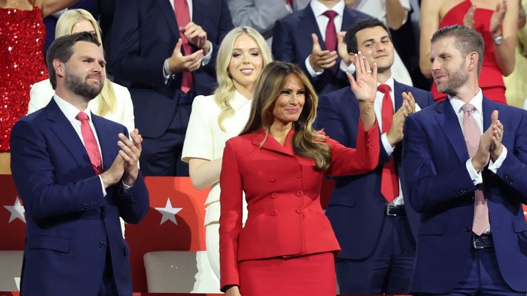 Former first lady Melania Trump waves as she is flanked by vice presidential nominee Senator J.D. Vance (R-OH) and Donald Trump Jr., as Republican presidential nominee and former U.S. President Donald Trump speaks on Day 4 of the Republican National Convention (RNC), at the Fiserv Forum in Milwaukee, Wisconsin, U.S., July 18, 2024. REUTERS/Andrew Kelly