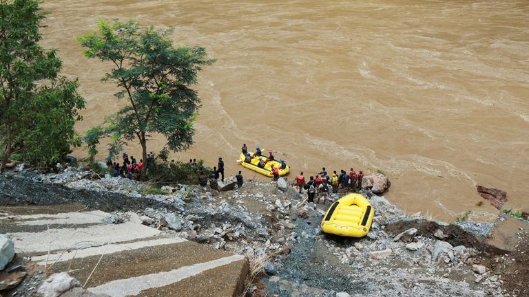 Members of rescue team search for the passenger buses that fell into the Trishuli River after the landslide at Simaltal area in Chitwan district, Nepal July 12, 2024. REUTERS/Stringer