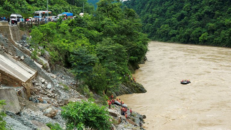 Members of rescue team search for the passenger buses that fell into the Trishuli River after the landslide at Simaltal area in Chitwan district, Nepal, July 12, 2024. REUTERS/Stringer