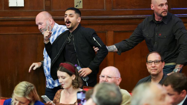 A heckler is escorted out as Reform UK Party Leader Nigel Farage speaks to the media.
Pic: Reuters