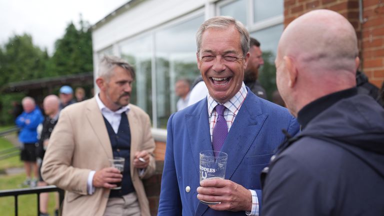 Nigel Farage is seen drinking a pint at a country club. Pic: PA