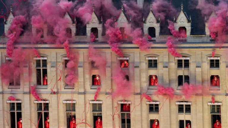 Smoke billows near windows as performers participate during the opening ceremony of the 2024 Summer Olympics.
Pic: AP