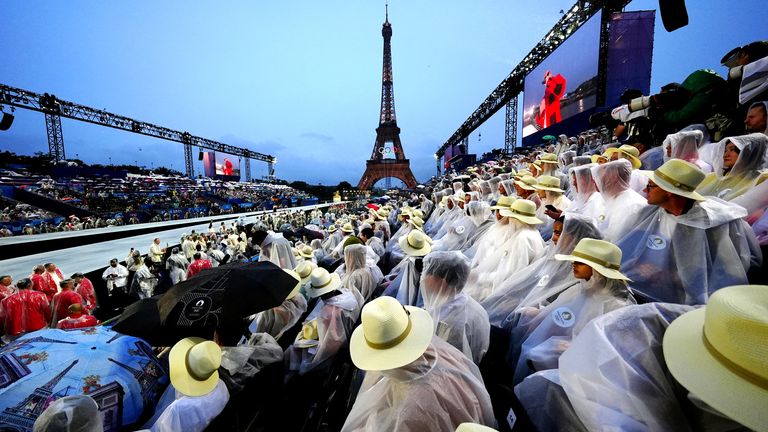 Spectators shelter from the rain at the Trocadero during the opening ceremony of the Paris 2024 Olympic Games 
Pic: PA