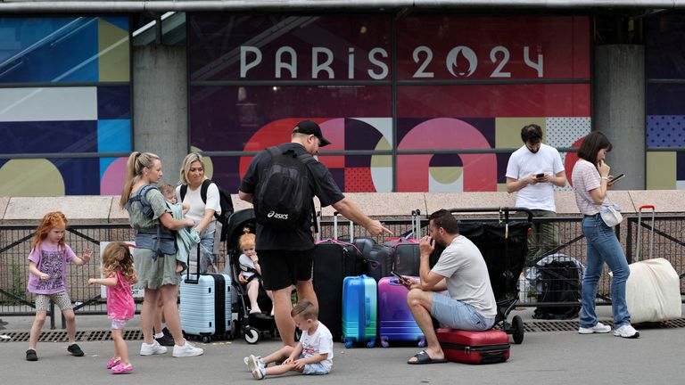 Travellers from Sydney, Australia, wait outside the Gare Montparnasse train station as they try to search for other trains after their trip was affected when vandals targeted France's high-speed train network with a series of coordinated actions that brought major disruption, ahead of the Paris 2024 Olympics opening ceremony, in Paris, France, July 26, 2024. REUTERS/Maye-E Wong TPX IMAGES OF THE DAY