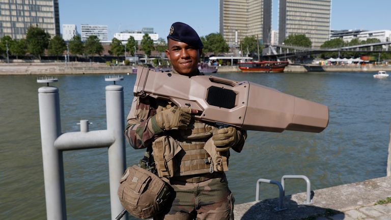 A soldier with a wave jammer on the River Seine. Pic: AP