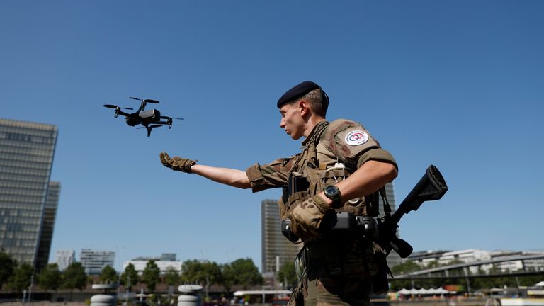 A soldier launches a drone over the Seine River. Pic: AP