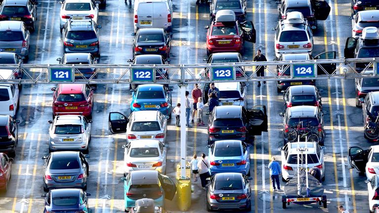 Passengers stand besides cars waiting to cross the channel at the Port of Dover in Kent.
Pic: PA