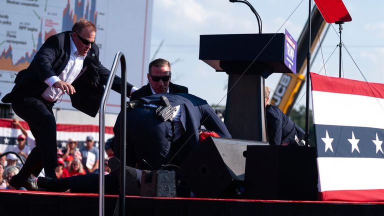 Donald Trump is surrounded by U.S. Secret Service agents.
Pic: AP