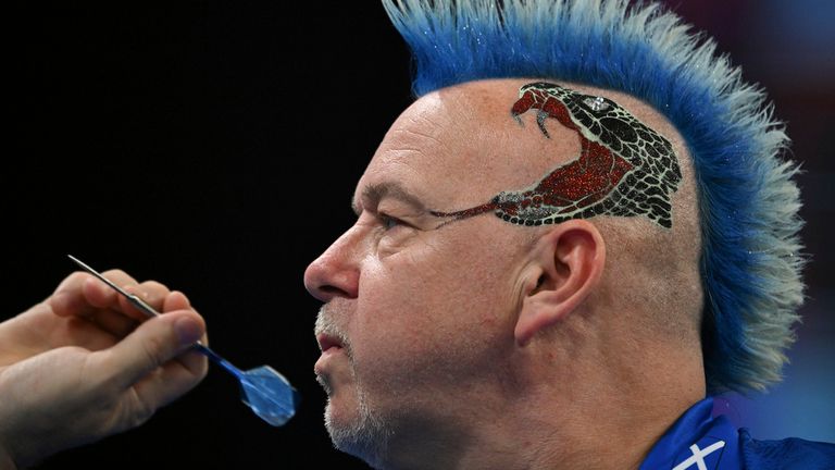 Peter Wright from Scotland competes in the quarter-final of the World Team Championship against Sweden.Pic: Arne Dedert/picture-alliance/dpa/AP

