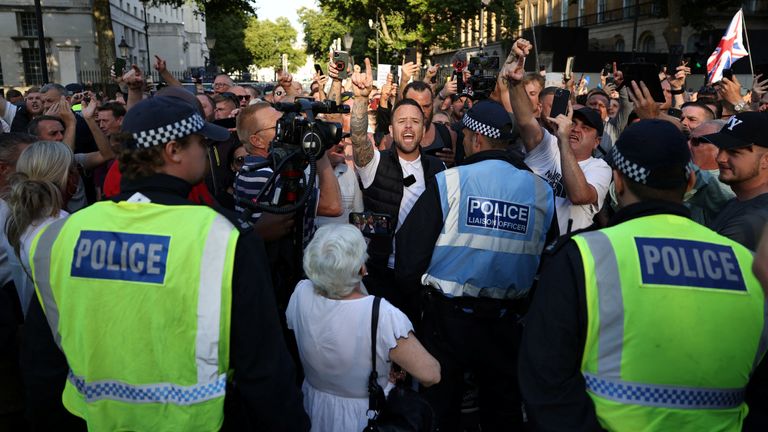 Police officers operate as people take part in a protest against illegal immigration outside of Downing Street in London Britain, July 31, 2024. REUTERS/Hollie Adams