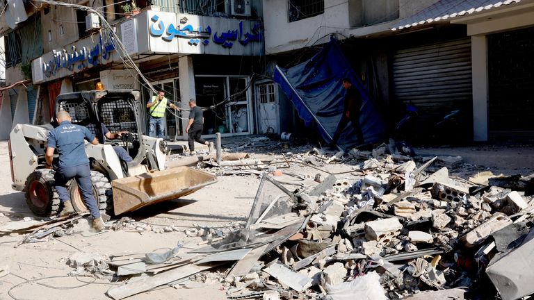 Police members remove the rubble at a damaged site the day after an Israeli strike, in Beirut.
Pic: Reuters