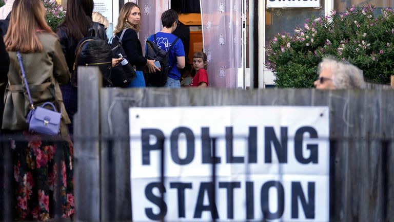 People queue at a polling station in London, Thursday, July 4, 2024. Voters in the U.K. are casting their ballots in a national election to choose the 650 lawmakers who will sit in Parliament for the next five years. Outgoing Prime Minister Rishi Sunak surprised his own party on May 22 when he called the election. (AP Photo/Vadim Ghirda)