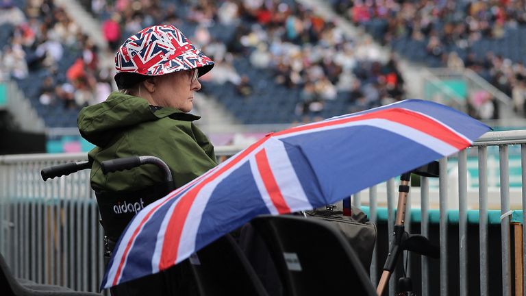 Britain fan looks on during the Eventing Individual Dressage amid poor weather in Paris. Pic: Reuters