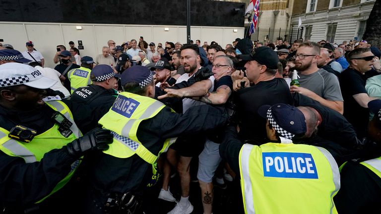 Police officers clash with people in Whitehall. Pic: PA