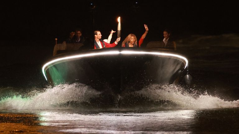 Rafael Nadal holds the Olympic torch alongside Serena Williams on a boat on the river Seine.
Pic Reuters