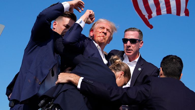 Donald Trump is surround by U.S. Secret Service agents at the campaign rally.
Pic: AP
