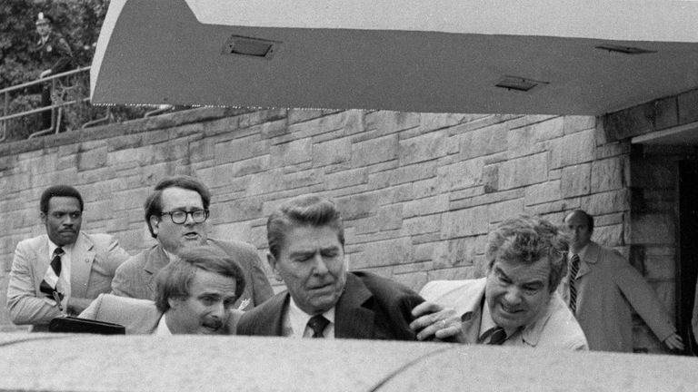 President Ronald Reagan is pushed into his limousine by Secret Service agents after being shot outside a Washington hotel on March 30, 1981. Photo: AP