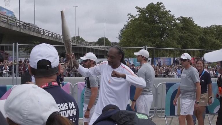 Snoop Dogg carries the Olympic torch in Saint-Denis