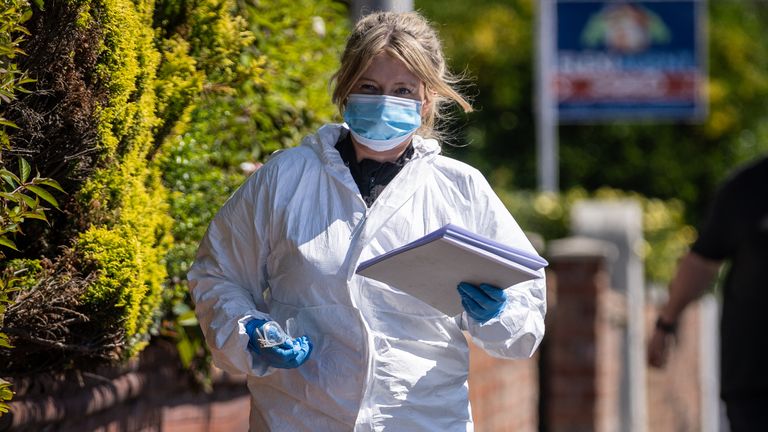 A police scenes of crime officer works at the scene in Southport