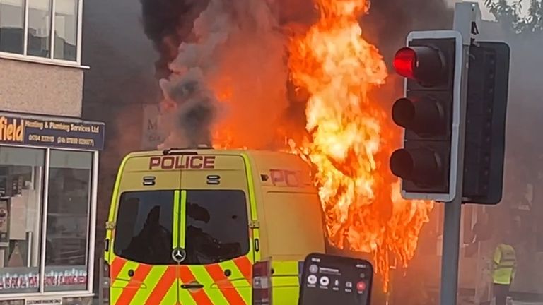 A police van has been set alight as a riot erupts outside a mosque in Southport. Pic: PA