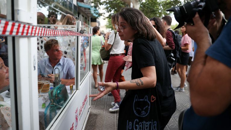 A demonstrator argues with tourists during a protest against mass tourism in Barcelona, Spain, July 6, 2024. The Catalan capital received more than 12 million tourists in 2023 and expects more in 2024. REUTERS/Bruna Casas