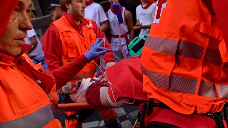 One man is taken away on a stretcher after being injured on Sunday. Pic: AP