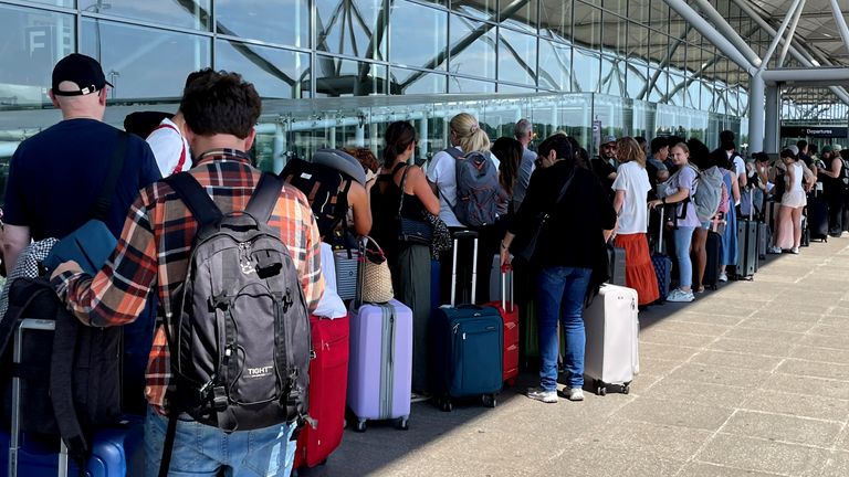 Passengers queuing outside London Stansted Airport in Essex after a worldwide IT outage caused chaos. Pic: PA