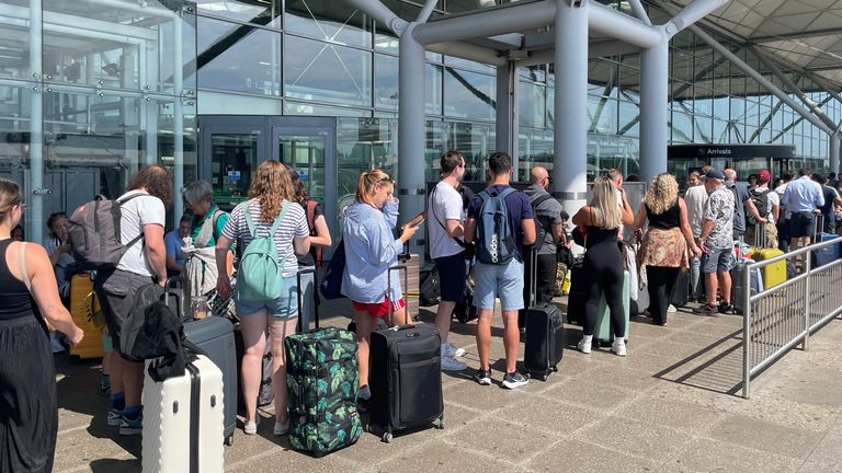 Passengers queue outside London Stansted Airport in Essex, amid reports of widespread IT outages affecting airlines, broadcasters and banks. Picture date: Friday July 19, 2024.