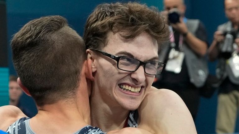 Stephen Nedoroscik, of United States, gets a hug from Paul Juda after last rotation during the men's artistic gymnastics team finals round at Bercy Arena at the 2024 Summer Olympics, Monday, July 29, 2024, in Paris, France. (AP Photo/Abbie Parr)