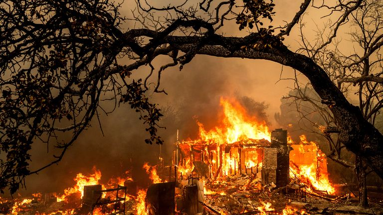 Flames consume a structure on Bessie Lane as the Thompson Fire burns in Oroville, Calif., July 2, 2024. (AP Photo/Noah Berger)