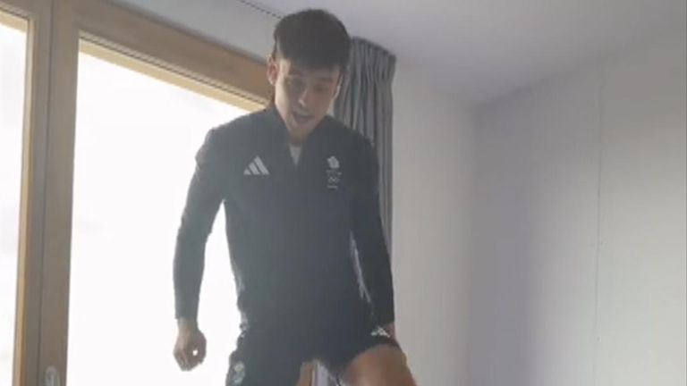 Tom Daley jumps up and down on a cardboard bed