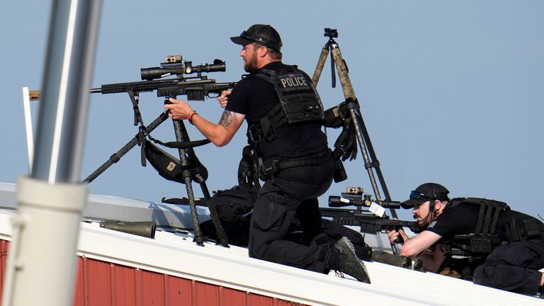 Police snipers return fire after shots were fired at Trump. Pic: AP