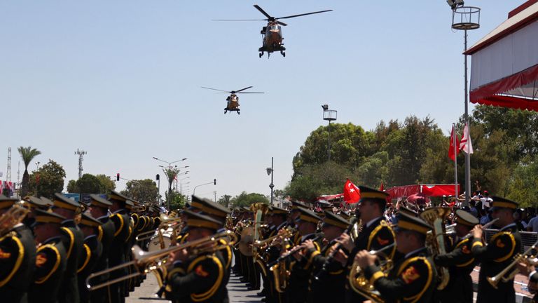 Helicopters fly during a military parade to mark the 1974 Turkish invasion of Cyprus in response to a short-lived Greek-inspired coup, in the Turkish-controlled northern Cyprus, in the divided city of Nicosia, Cyprus July 20, 2024. REUTERS/Yiannis Kourtoglou