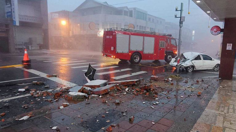 In this photo taken Wednesday, July 24, 2024 and released by Hualien Fire Department, show a car being hit by falling walls after Typhoon Gaemi made landfall in Hualien county, Taiwan. (Hualien Fire Department via AP)