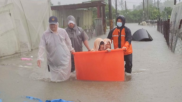 This photo released by Pingtung Fire Department shows, local residents being evacuated during floods after Typhoon Gaemi made landfall in Pintung county, Taiwan, Thursday, July 25, 2024. (Pingtung Fire Department via AP)