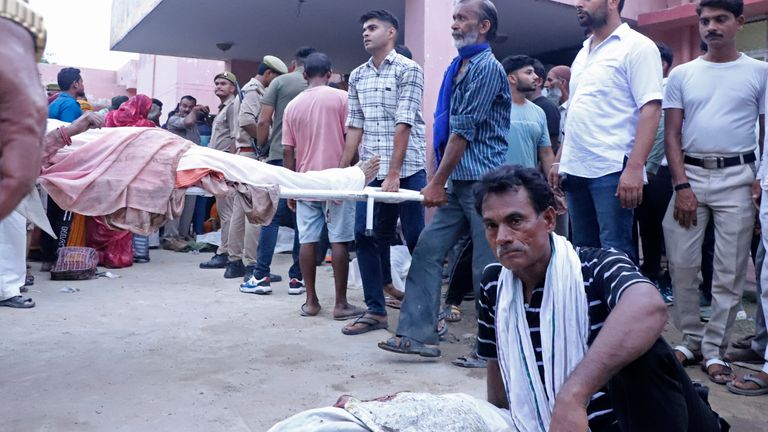 Relatives carry body of a man on a stretcher. Pic: AP