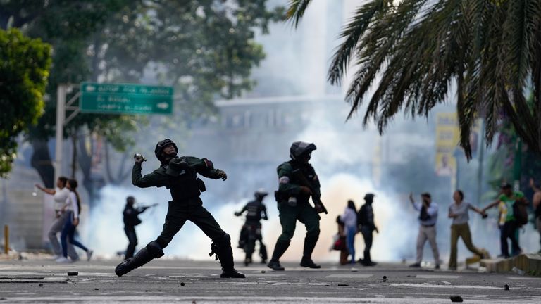 Police throw a gas canister at protesters. Pic: AP