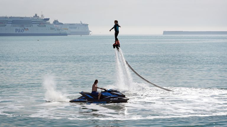 A lady enjoys flyboarding during the warm weather on the beach in Dover, Kent. South-eastern England is likely to see the UK's hottest day of the year far on Friday, although the UK as a whole will face a mixed picture on Friday and into the weekend. Picture date: Friday July 19, 2024. Gareth Fuller/PA Wire