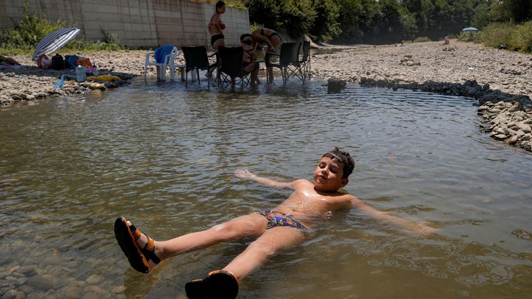 A youngster cools off in the Erenik River in Kosovo. Pic: Reuters