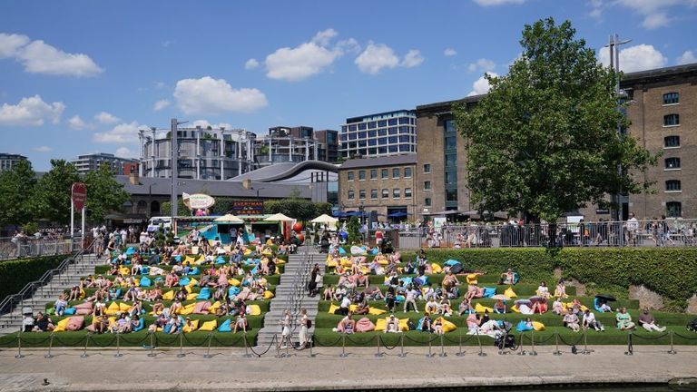 People enjoying the warm weather in Granary Square, London. South-eastern England is likely to see the UK's hottest day of the year so far on Friday, although the UK as a whole will face a mixed picture on Friday and into the weekend. Picture date: Friday July 19, 2024. Pic: PA 