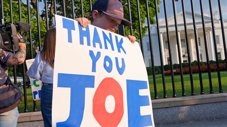 Hugh Kieve, 10, of Washington, holds a sign outside the White House in Washington, Sunday, July 21, 2024, as he and his family come out to show support for President Joe Biden. Biden dropped out of the 2024 race for the White House on Sunday, ending his bid for reelection following a disastrous debate with Donald Trump that raised doubts about his fitness for office just four months before the election. (AP Photo/Susan Walsh)