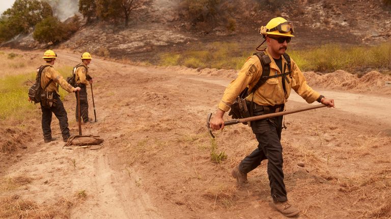 Firefighters work against the advance of the Lake Fire in Los Olivos, California, on Saturday, July 6, 2024. (AP Photo/Eric Thayer)