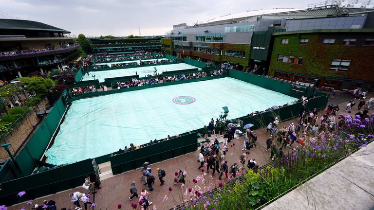 A general view of covers on the outside courts as rain delays the start of play on day three of the 2024 Wimbledon Championships at the All England Lawn Tennis and Croquet Club, London. Picture date: Wednesday July 3, 2024.